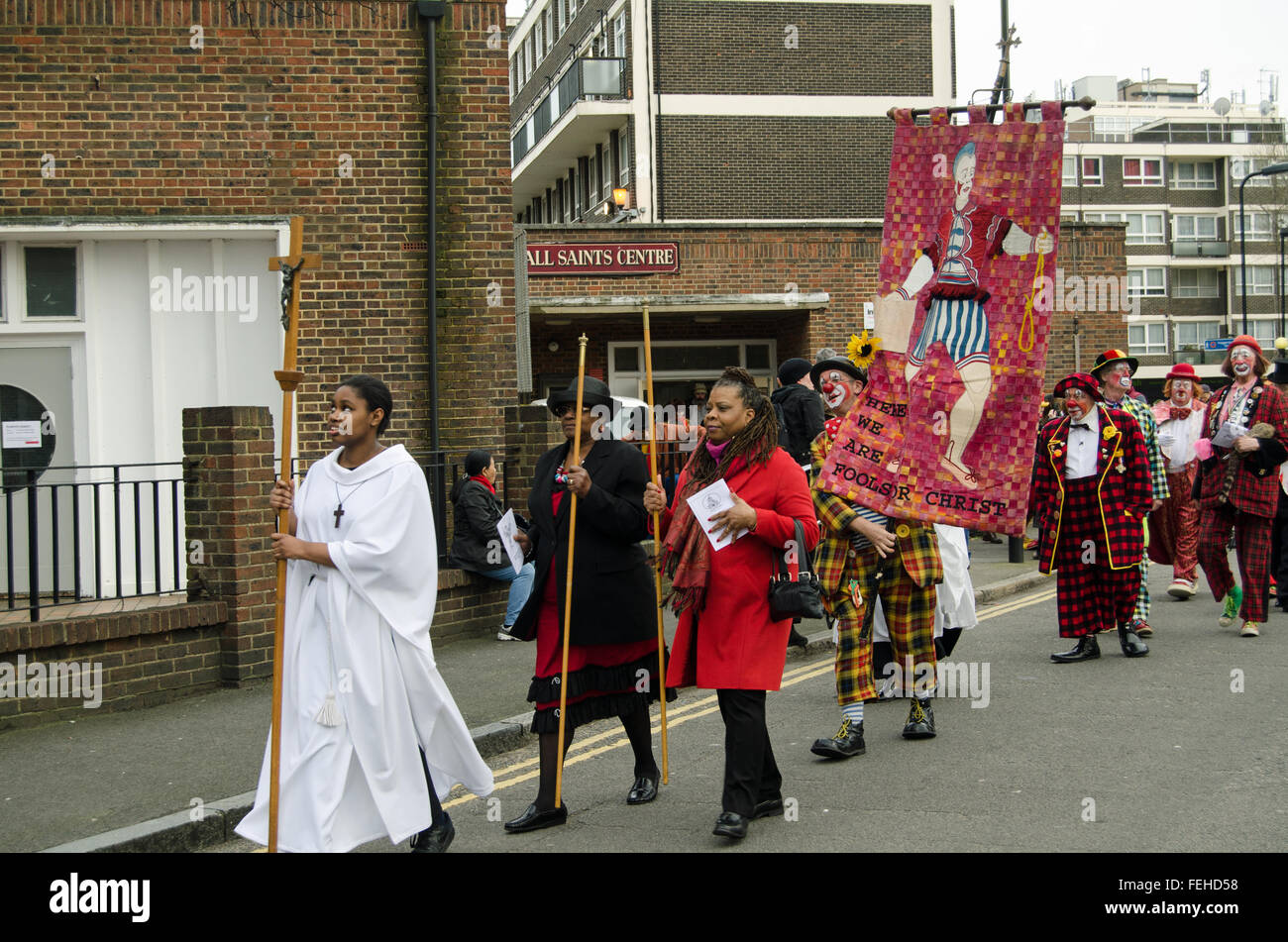 Hackney, London, UK. 7th February, 2016. Church officials and clowns process along the road to the annual memorial for Joseph Grimaldi, considered to be the King of Clowns.  All Saints Church, Haggerston, Hackney, East London. Credit:  Amanda Lewis/Alamy Live News Stock Photo