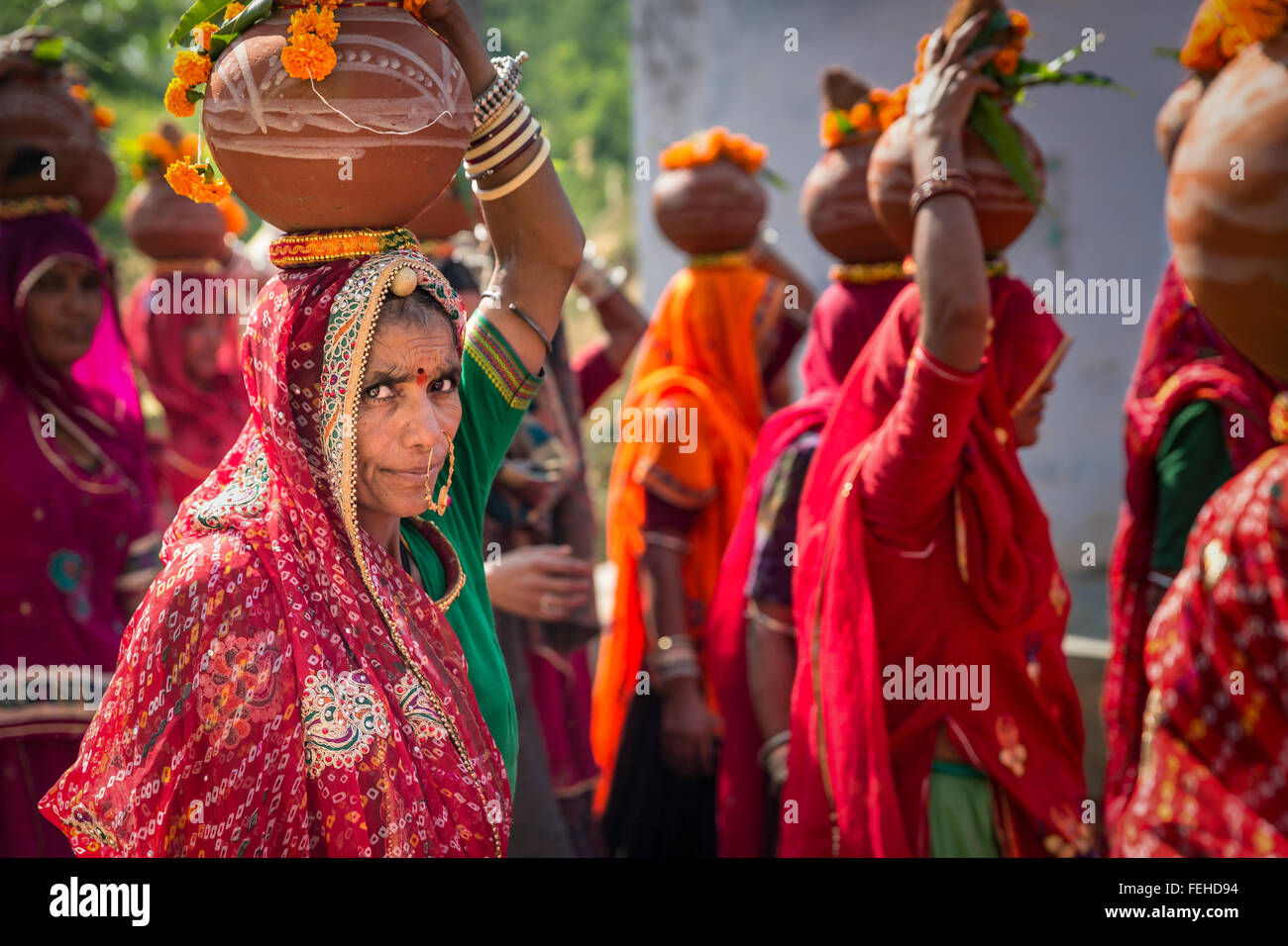 Indian women carrying offerings on their heads during a festival, Pushkar, Rajasthan, India Stock Photo