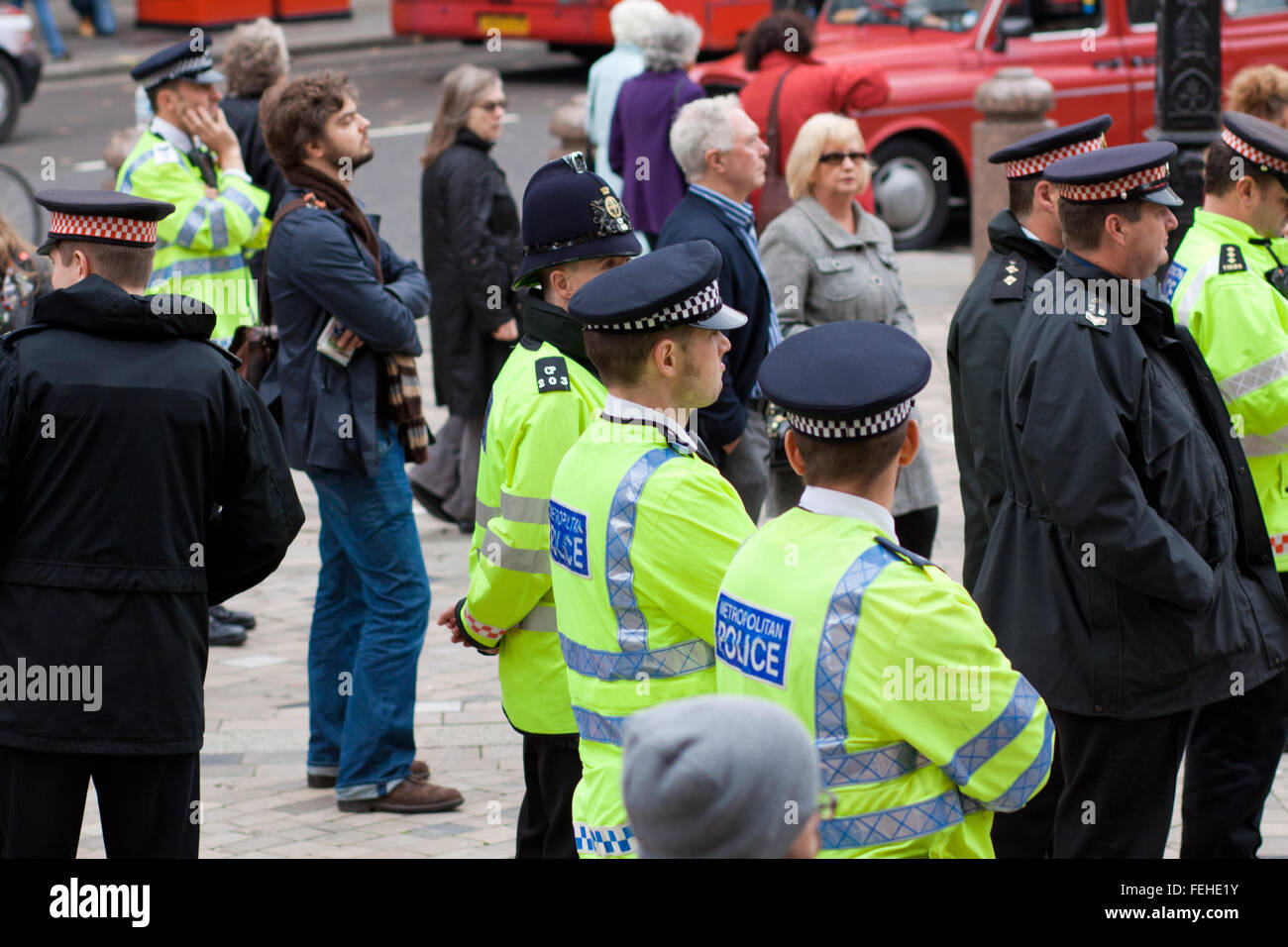 Row of police officers watching speeches at the Occupy London protest outside St. Paul's Cathedral, central London. Stock Photo