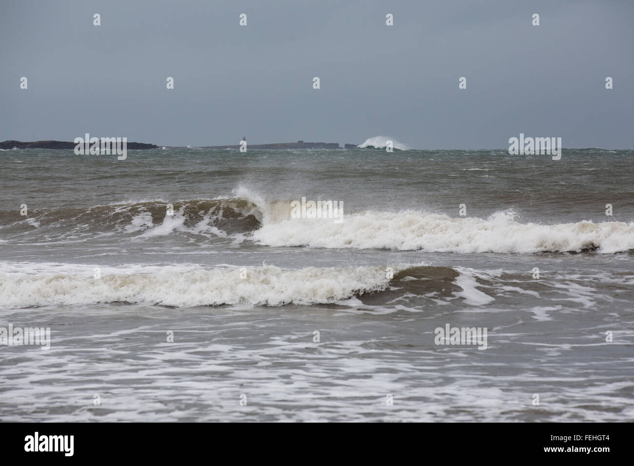 Northumberland, UK. 7th February, 2016. UK Weather: Waves on the North Sea crash against the Farne Islands off the coast of Northumberland, England. The wind whips the whitecaps of the waves. Credit:  Stuart Forster/Alamy Live News Stock Photo
