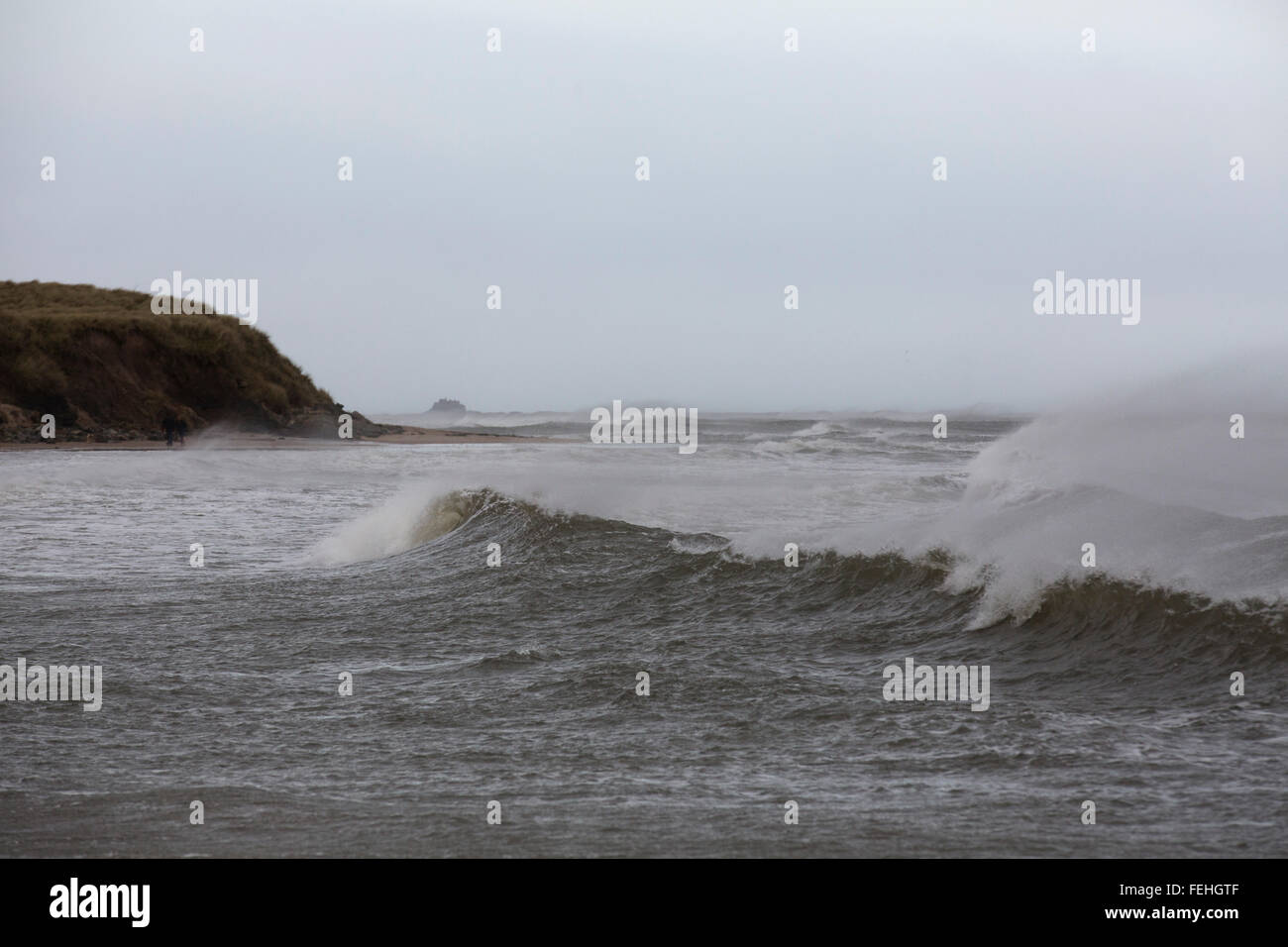 Northumberland, UK. 7th February, 2016. UK Weather: The beach near North Sunderland and Seahouses in Northumberland, England. Waves with whitecaps break next to the beach. Credit:  Stuart Forster/Alamy Live News Stock Photo