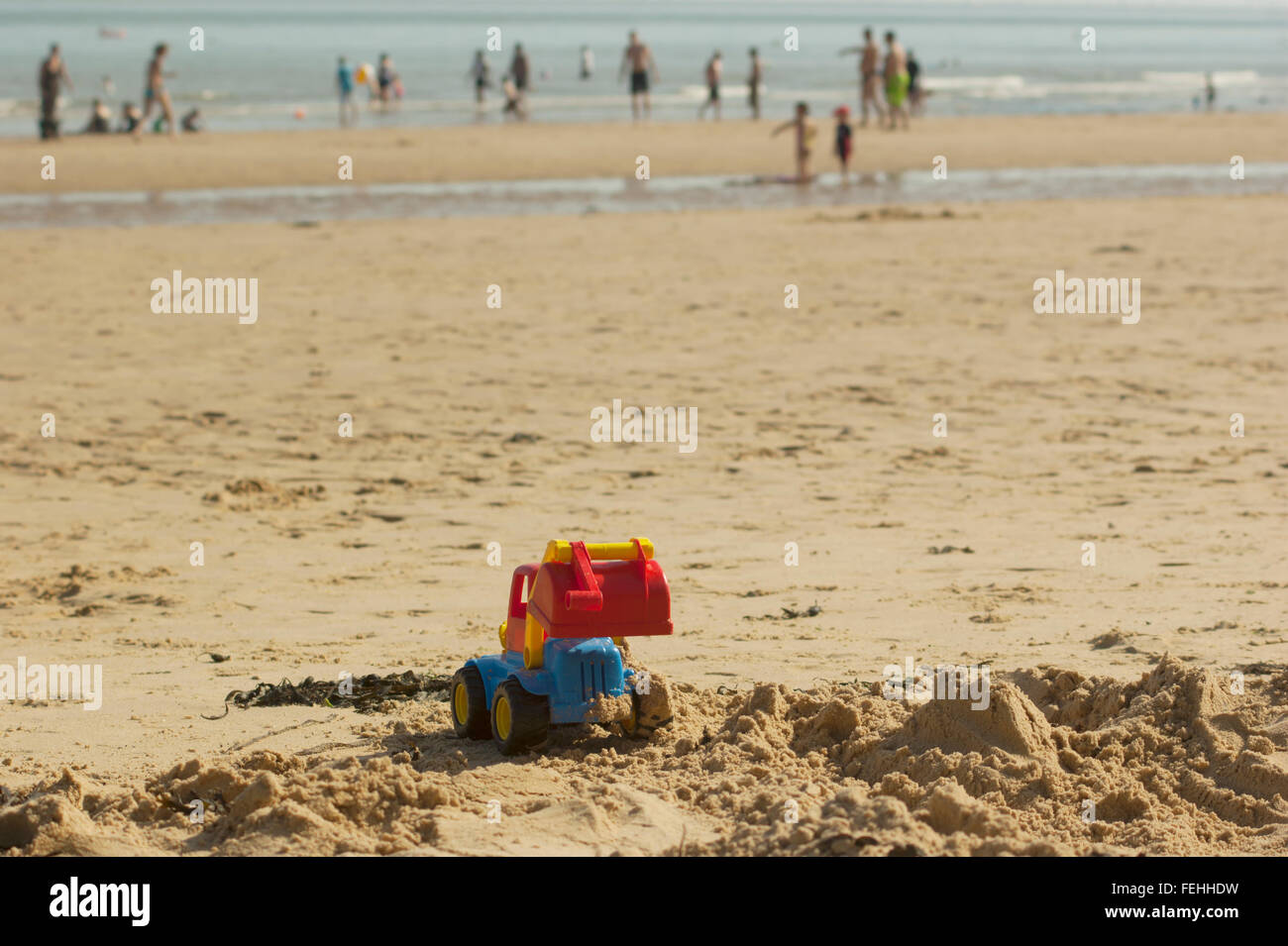 Child's digger toy on beach at Walton on the Naze, Essex , England , UK Stock Photo