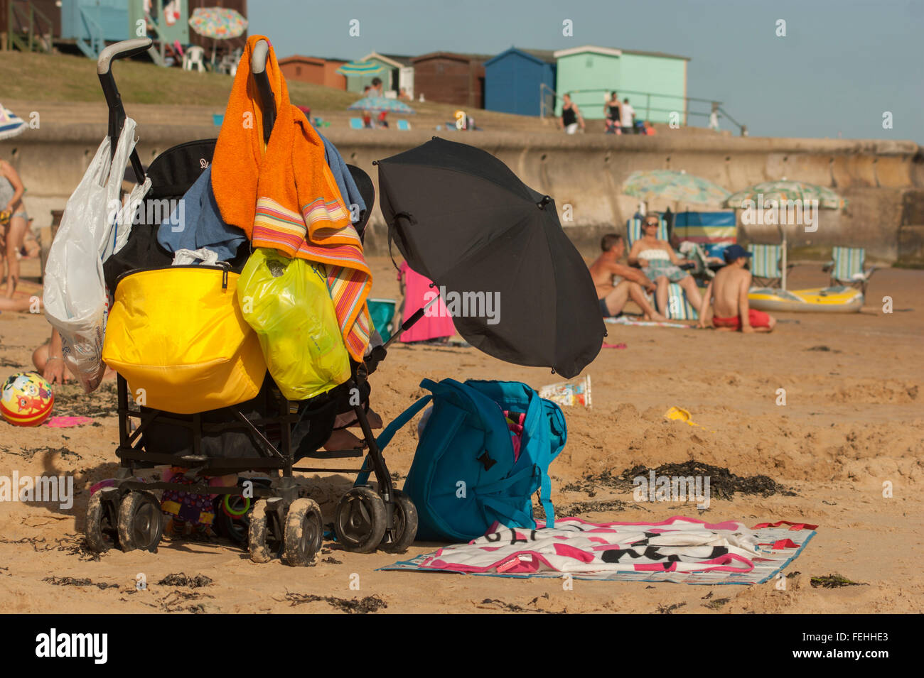View of an overladen pushchair on a day out, Seen on the beach at Walton on the Naze , Essex, UK. Stock Photo