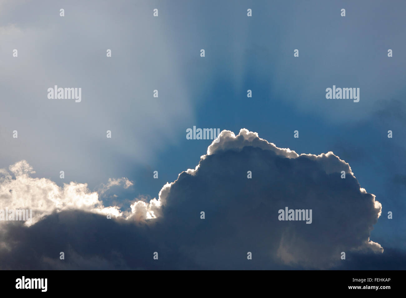sun behind a cloud Stock Photo