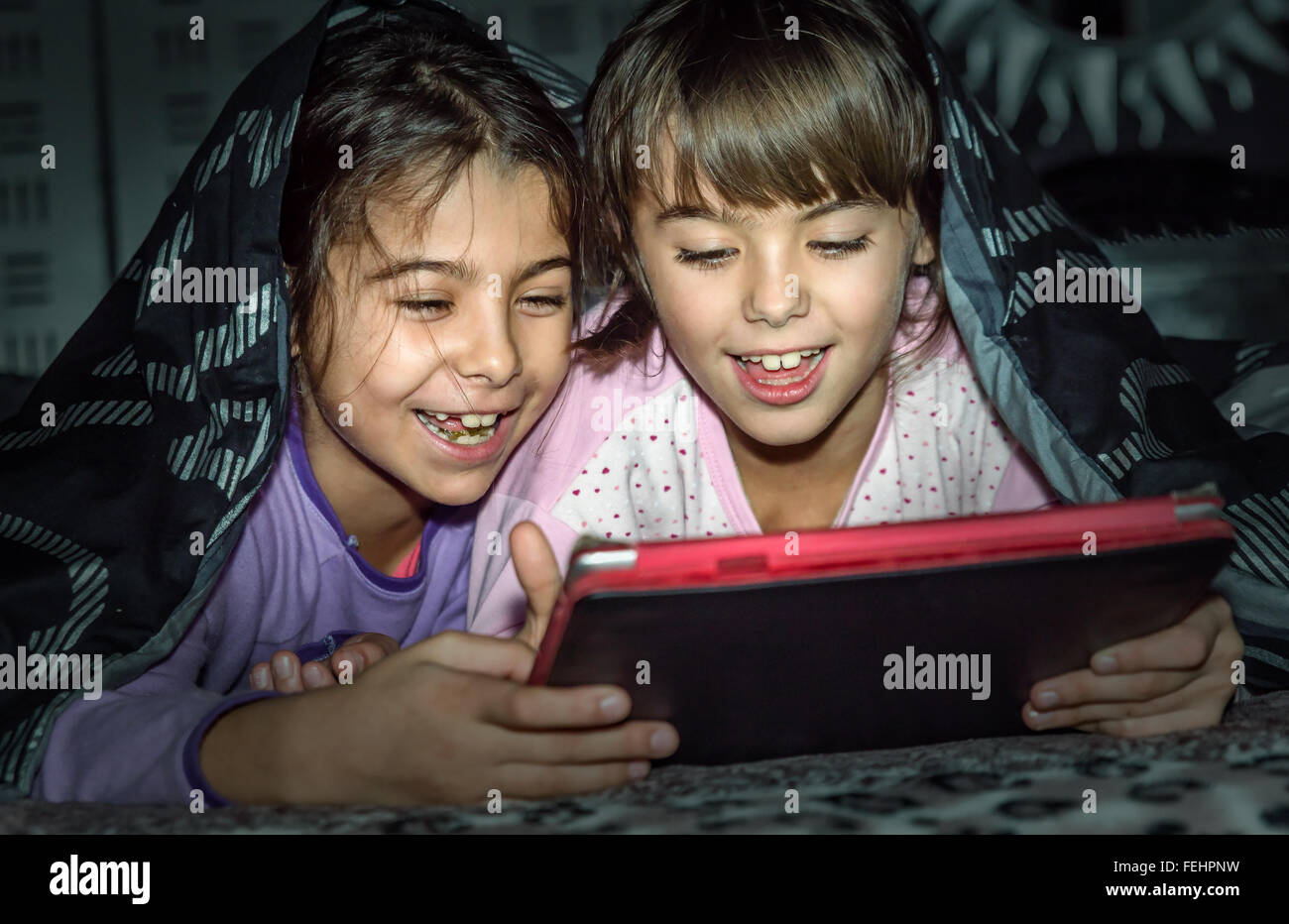Kid hiding under blanket hires stock photography and images Alamy