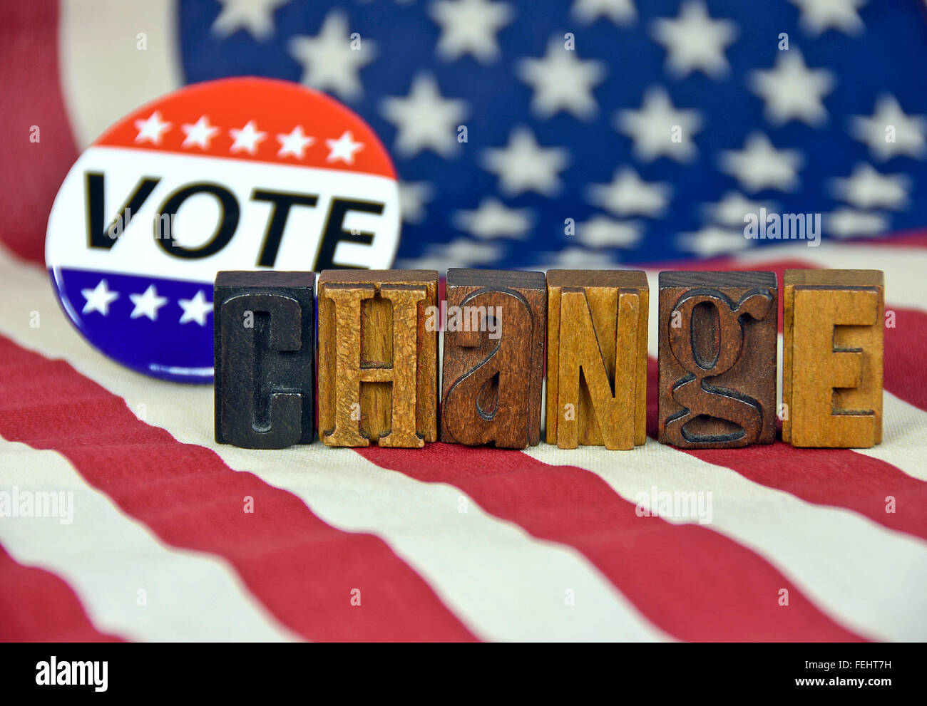 Patriotic vote button and vintage letterpress type on American flag. Stock Photo