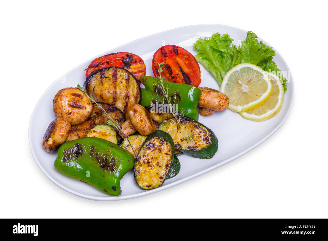 Grilled vegetables on the long white plate, isolated with clipping path Stock Photo