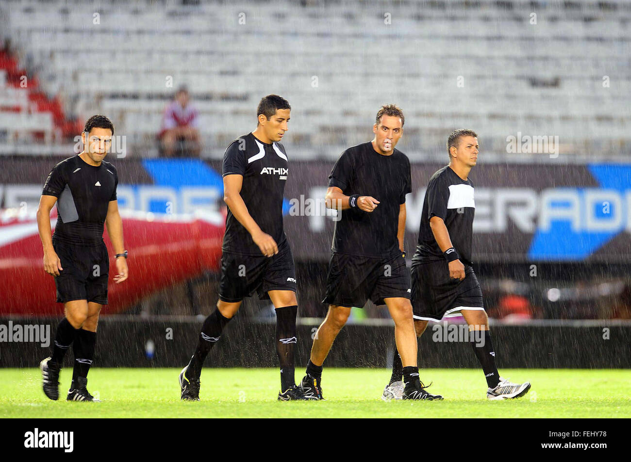 Buenos Aires, Argentina. 7th Feb, 2016. Referee Fernando Rapallini and his colleagues leave the field after stopping the match of the Tournament First Division between River Plate and Quilmes, held at the Antonio Vespuci Monumental Stadium, in the city of Buenos Aires, capital of Argentina, on Feb. 7, 2016. A heavy rain forced the suspension of the match, and it was rescheduled. © Maximiliano Luna/TELAM/Xinhua/Alamy Live News Stock Photo