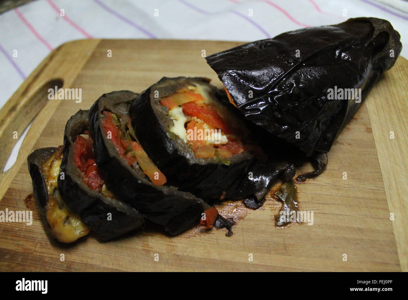 appetizing healthy eggplant baked with vegetables inside cut on slices Stock Photo