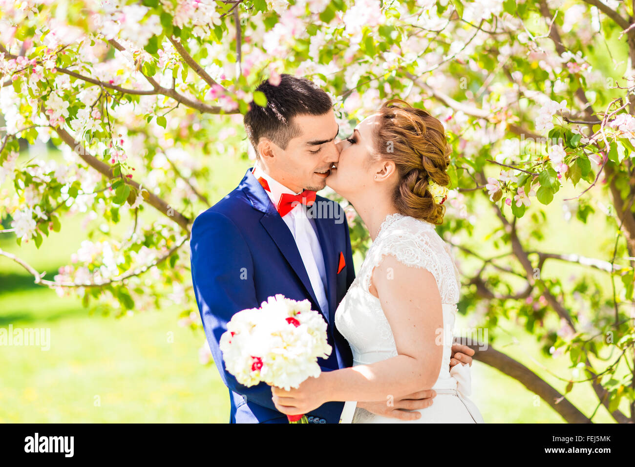 Couple kissing at blooming tree hi-res stock photography and images - Alamy