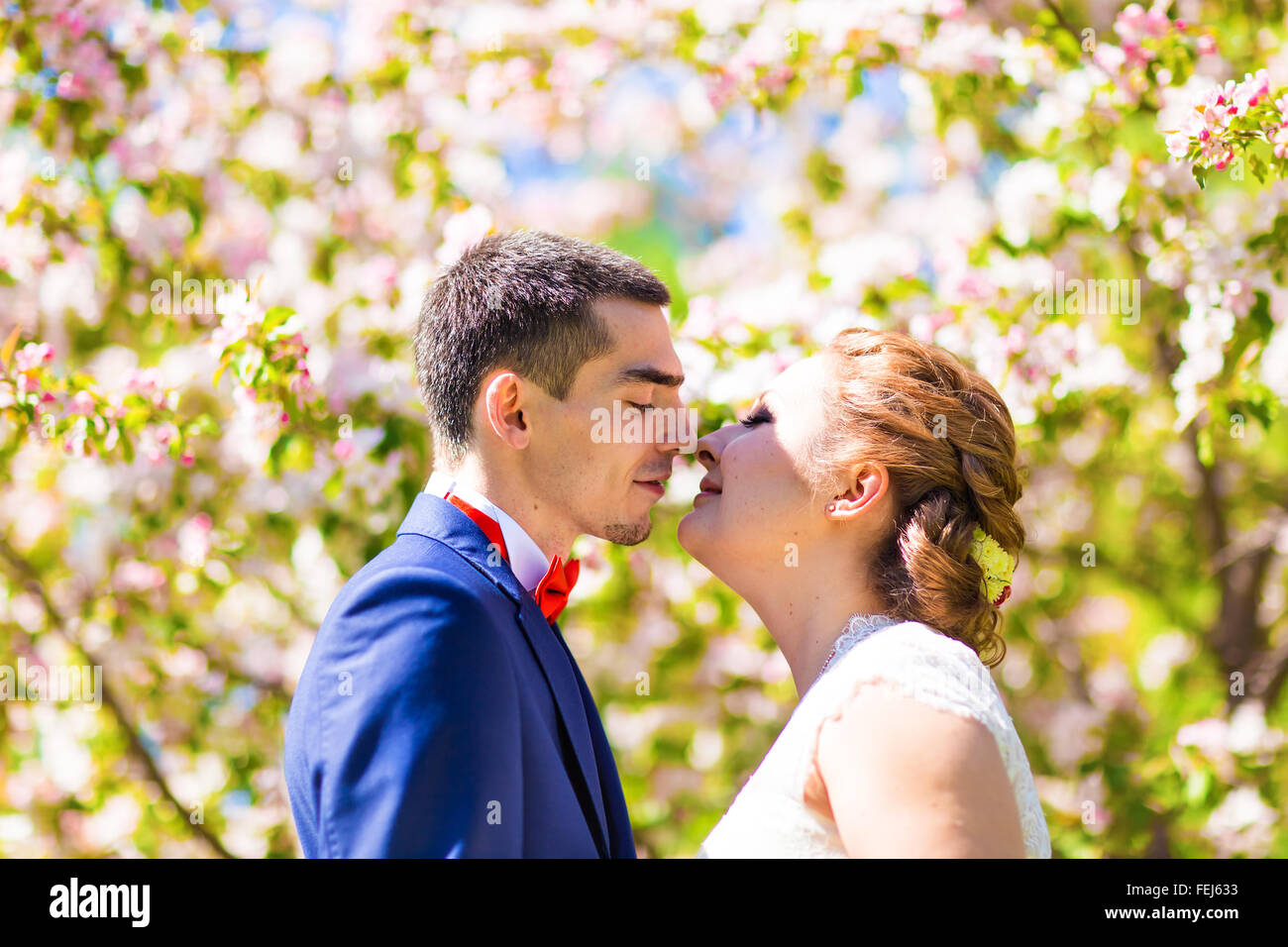 Couple kissing at blooming tree hi-res stock photography and images - Alamy