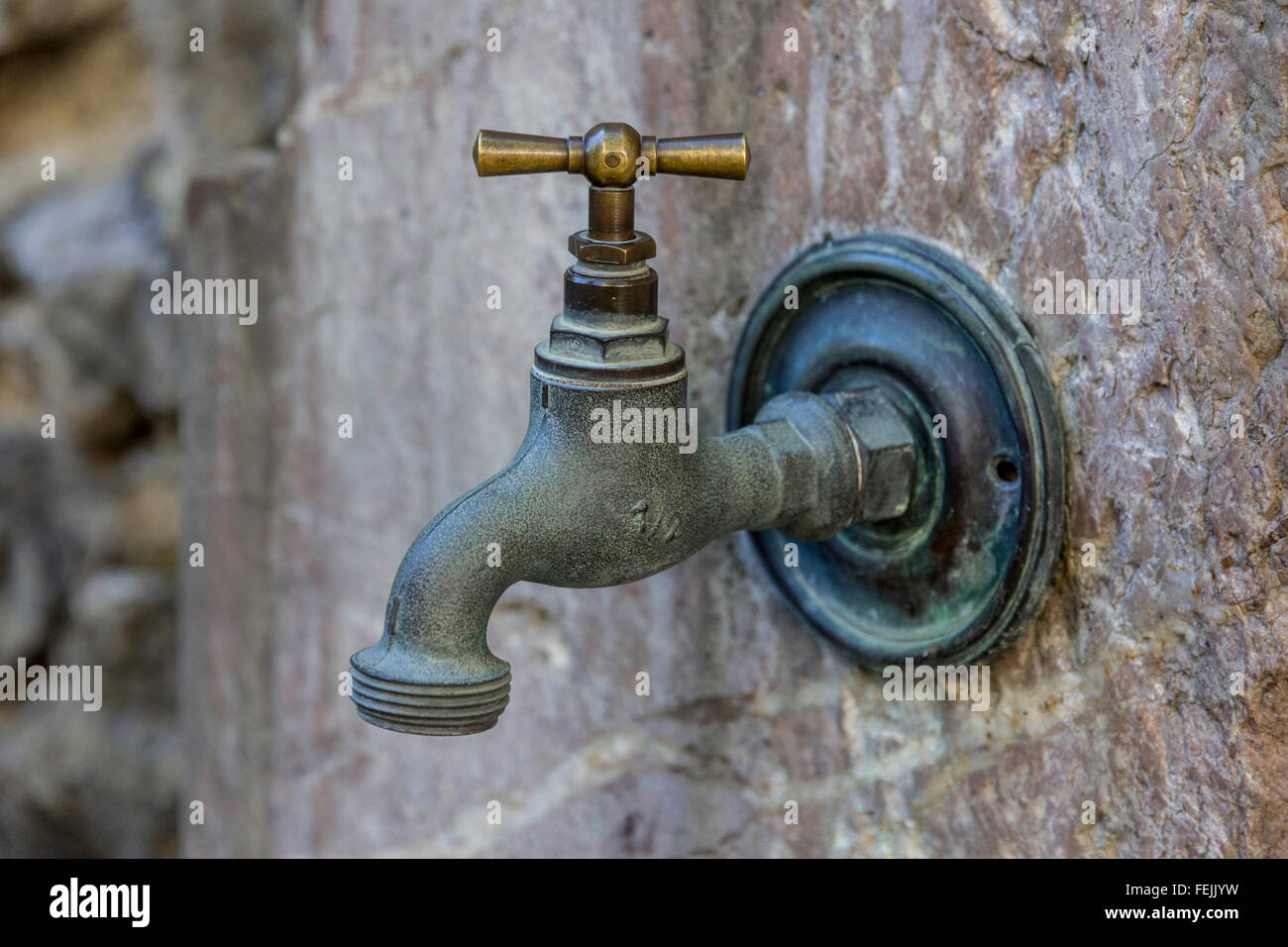 Tap and surround fitted to an old wall Stock Photo