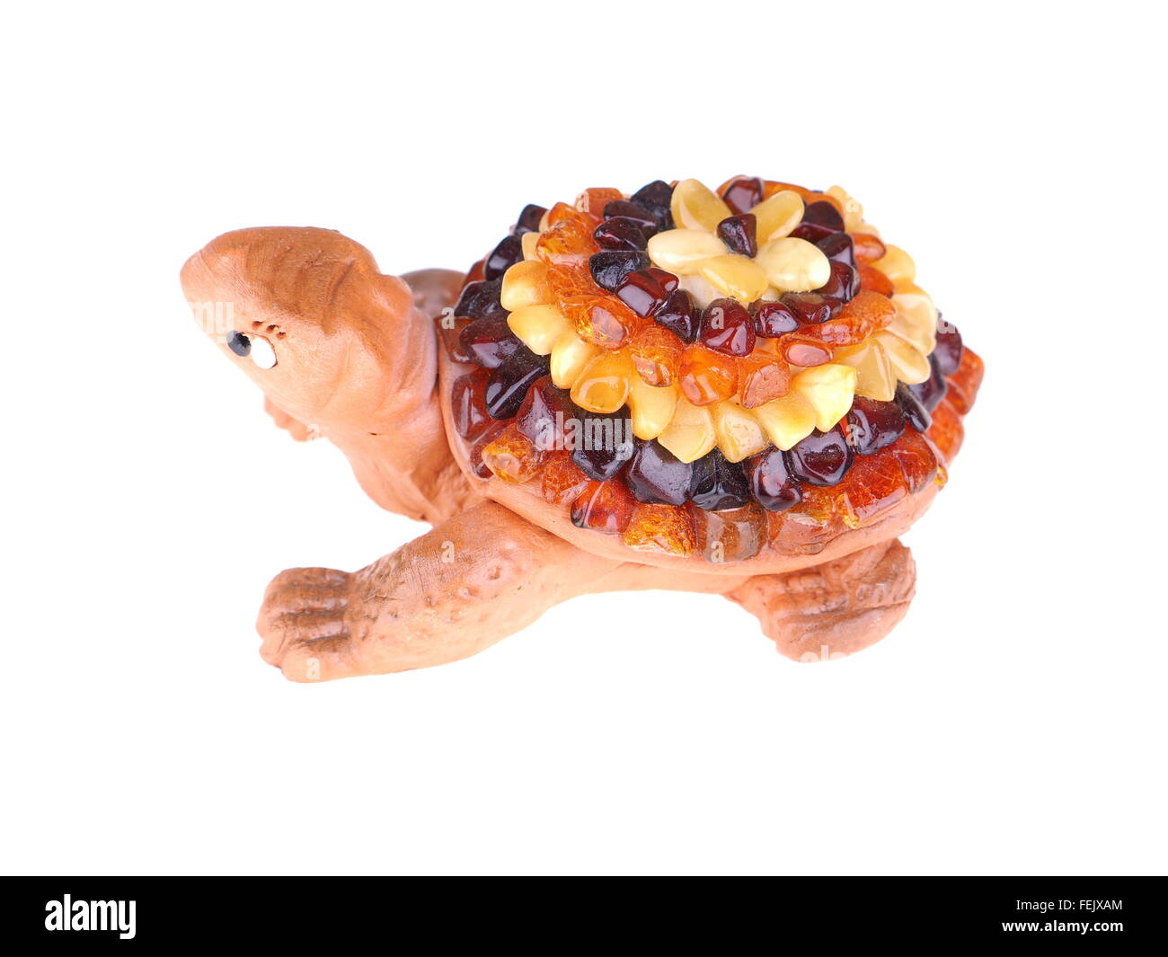 toy turtle with a shell made of amber on a white background Stock Photo