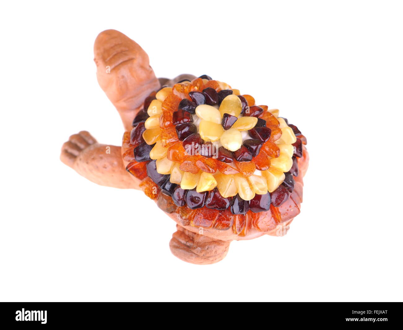 toy turtle with a shell made of amber on a white background Stock Photo