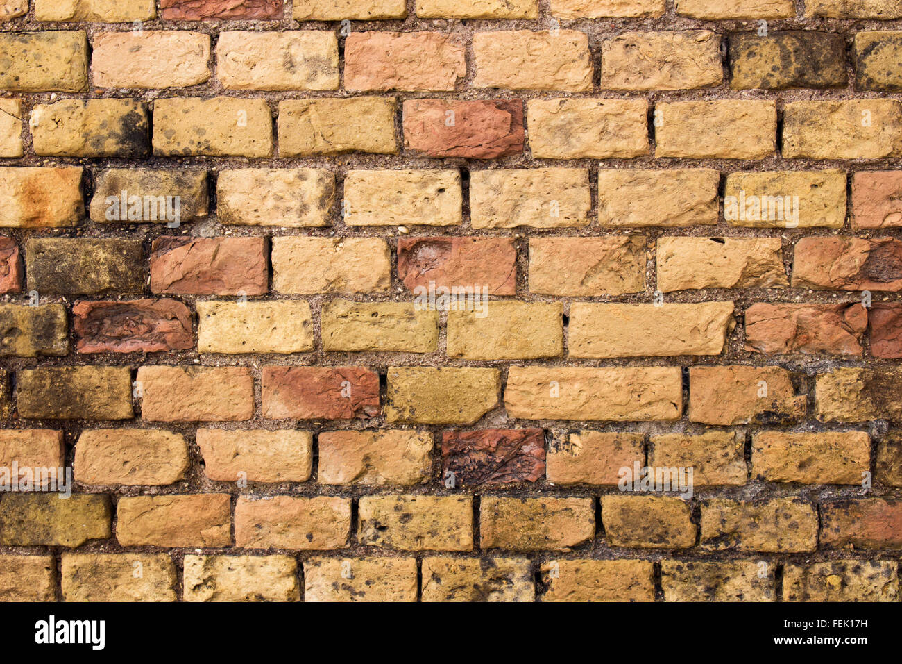 old, textured bricks wall background. construction weathered, rough surface. grungy, abstract wallpaper Stock Photo