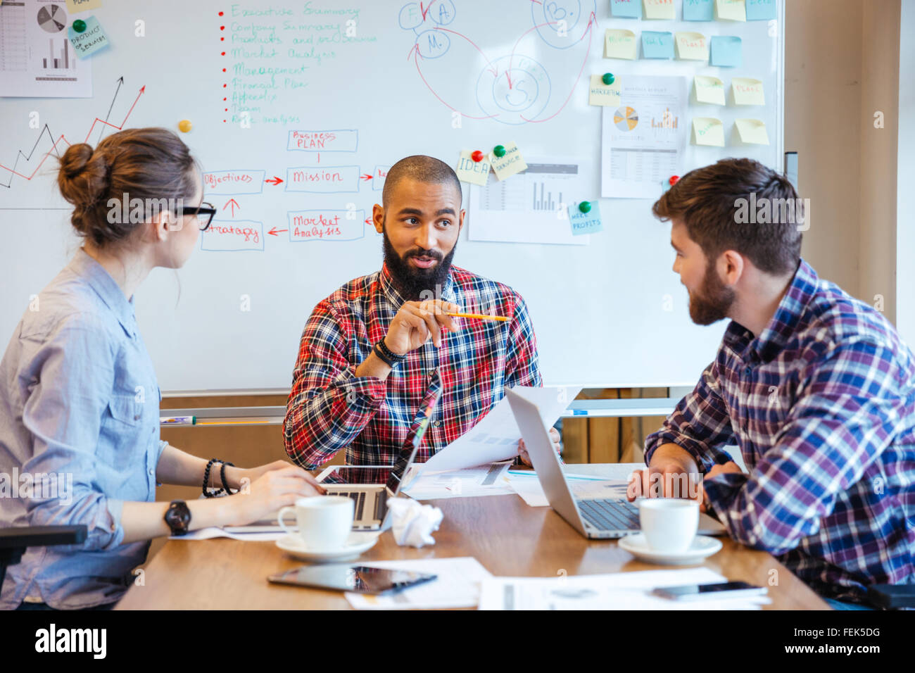Group of creative young people making new project together in conference room Stock Photo