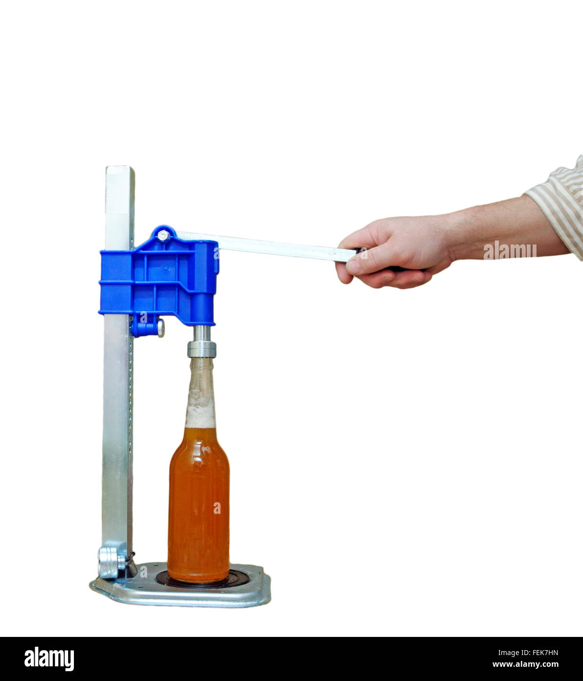 Manual capping machine for bottles on a white background Stock Photo