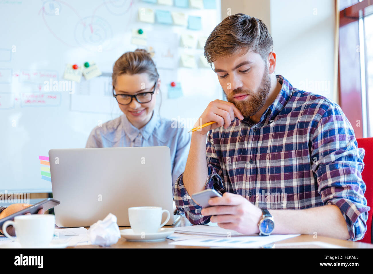 Young business people working in office Stock Photo - Alamy
