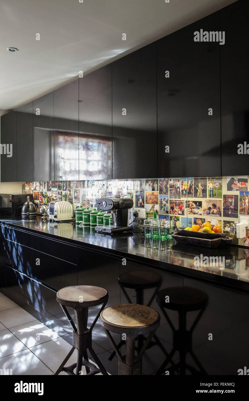Parfumier Azzi Glasser's home in North London. The kitchen with bold black built-n cupboards Stock Photo