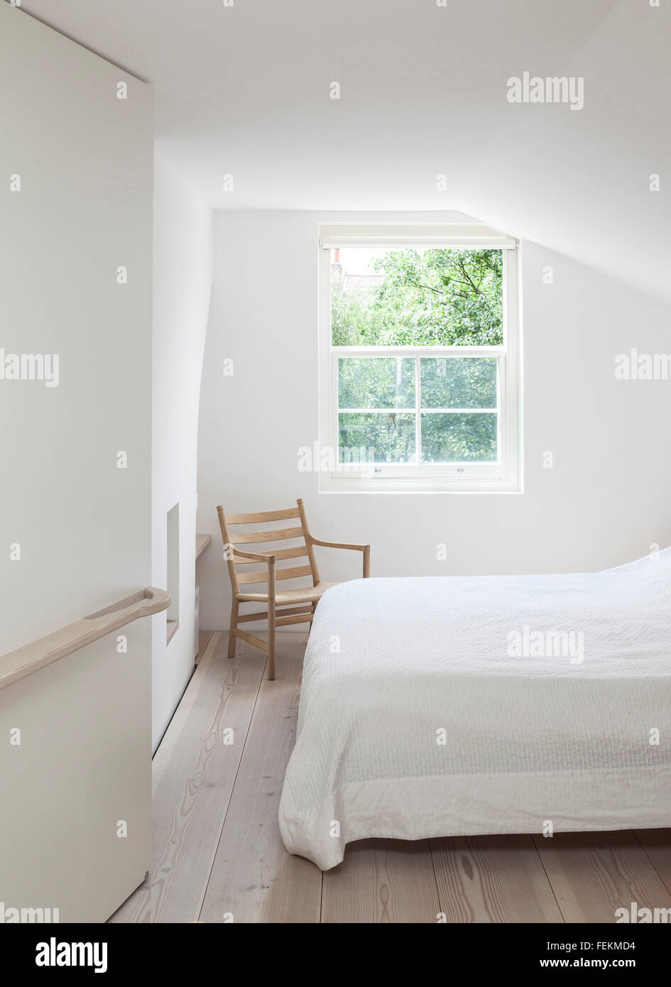 James Wright of Macdonald Wright Architects' home in London A minimalistic upper floor bedroom with interesting lines following Stock Photo