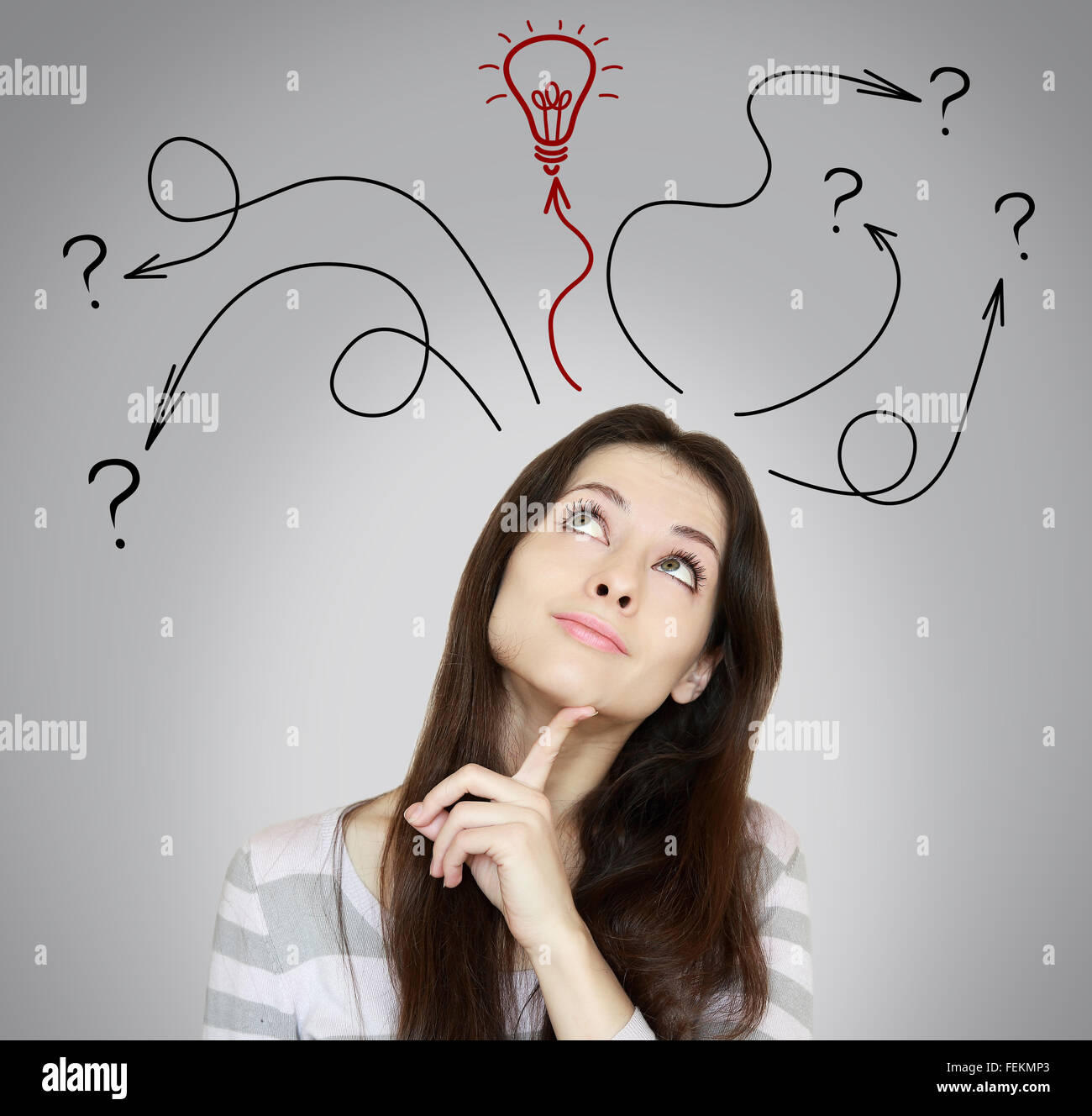 Thinking woman making decision and have an idea. She looking up on grey background Stock Photo