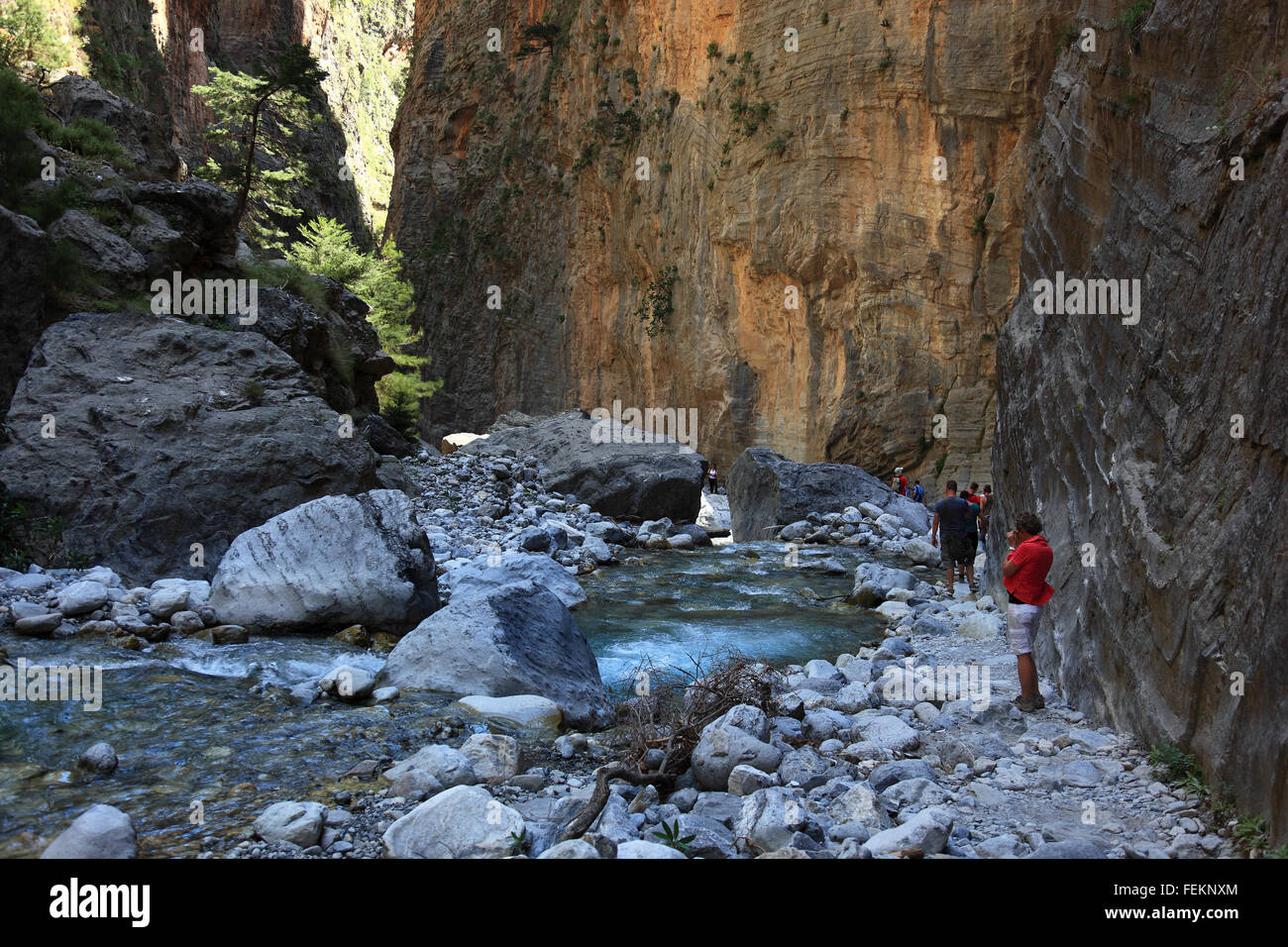 Crete, traveller in the Samaria gulch, way by the brook bed along in high cliff faces Stock Photo