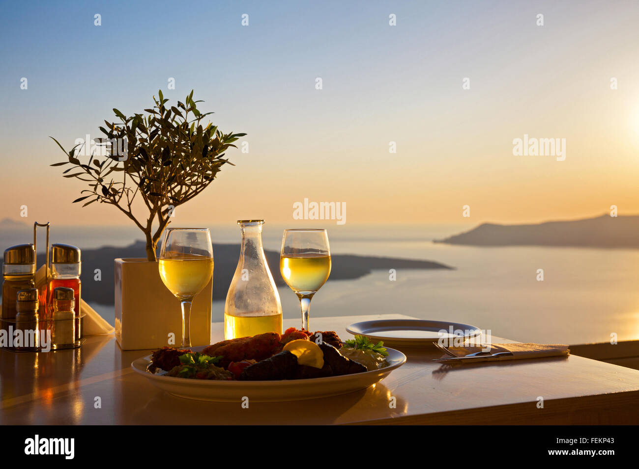 Romantic table for two on the island Santorini, Greece. Views of the ...