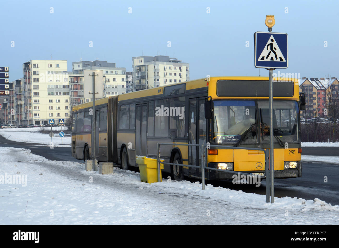 VILNIUS, LITHUANIA - JANUARY 03, 2016: The old yellow passenger city bus Mercedes at the winter  evening  frozen stop of the sma Stock Photo