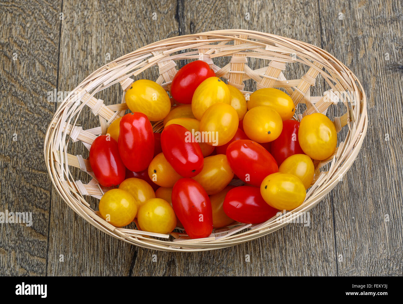 Yellow and red cherry tomatoes mix on the basket Stock Photo - Alamy