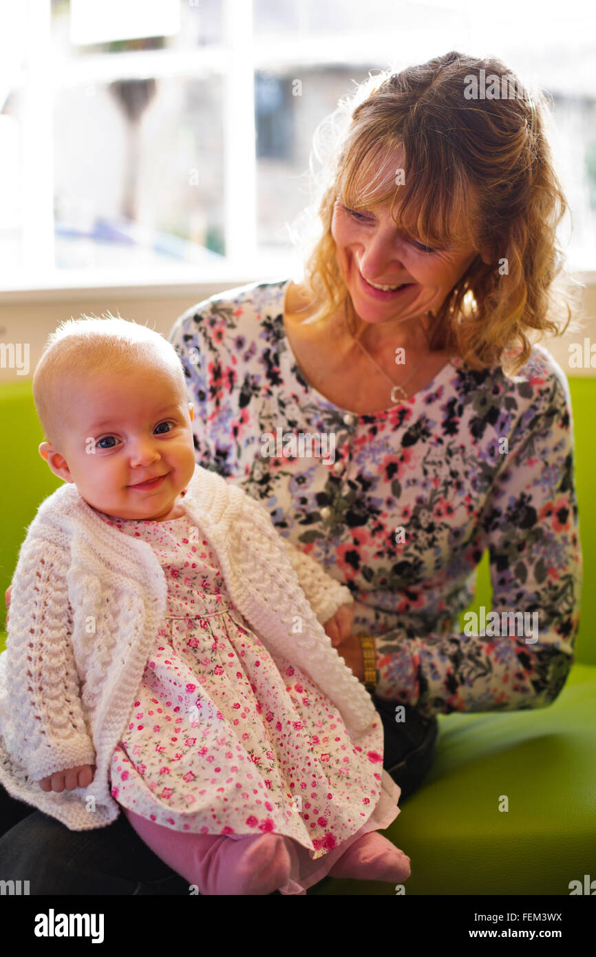 A tender loving moment as a grandmother holds her granddaughter. Stock Photo