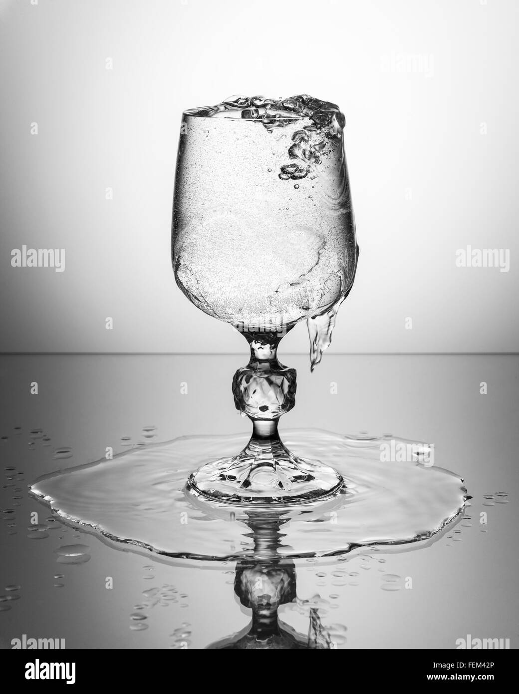 Wine glass with sparkling water pouring over Stock Photo Alamy
