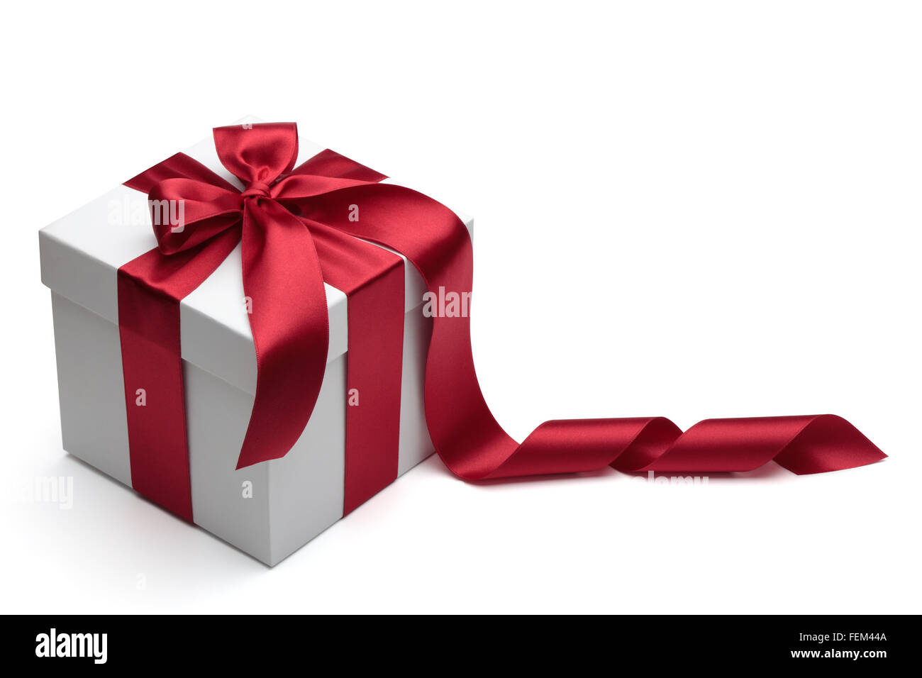 Gift box with red ribbon and bow isolated on the white background, clipping path included. Stock Photo