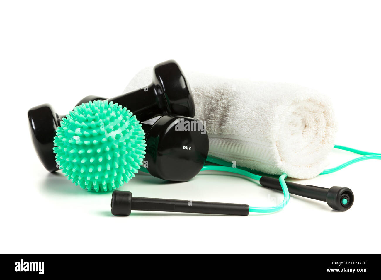 workout equipment on white background - massage ball, dumbbells, jump rope and towel Stock Photo