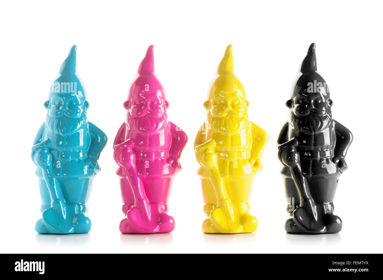 CMYK printing colors concept. Four garden gnomes in colors cyan, magenta, yellow and black isolated on white background Stock Photo