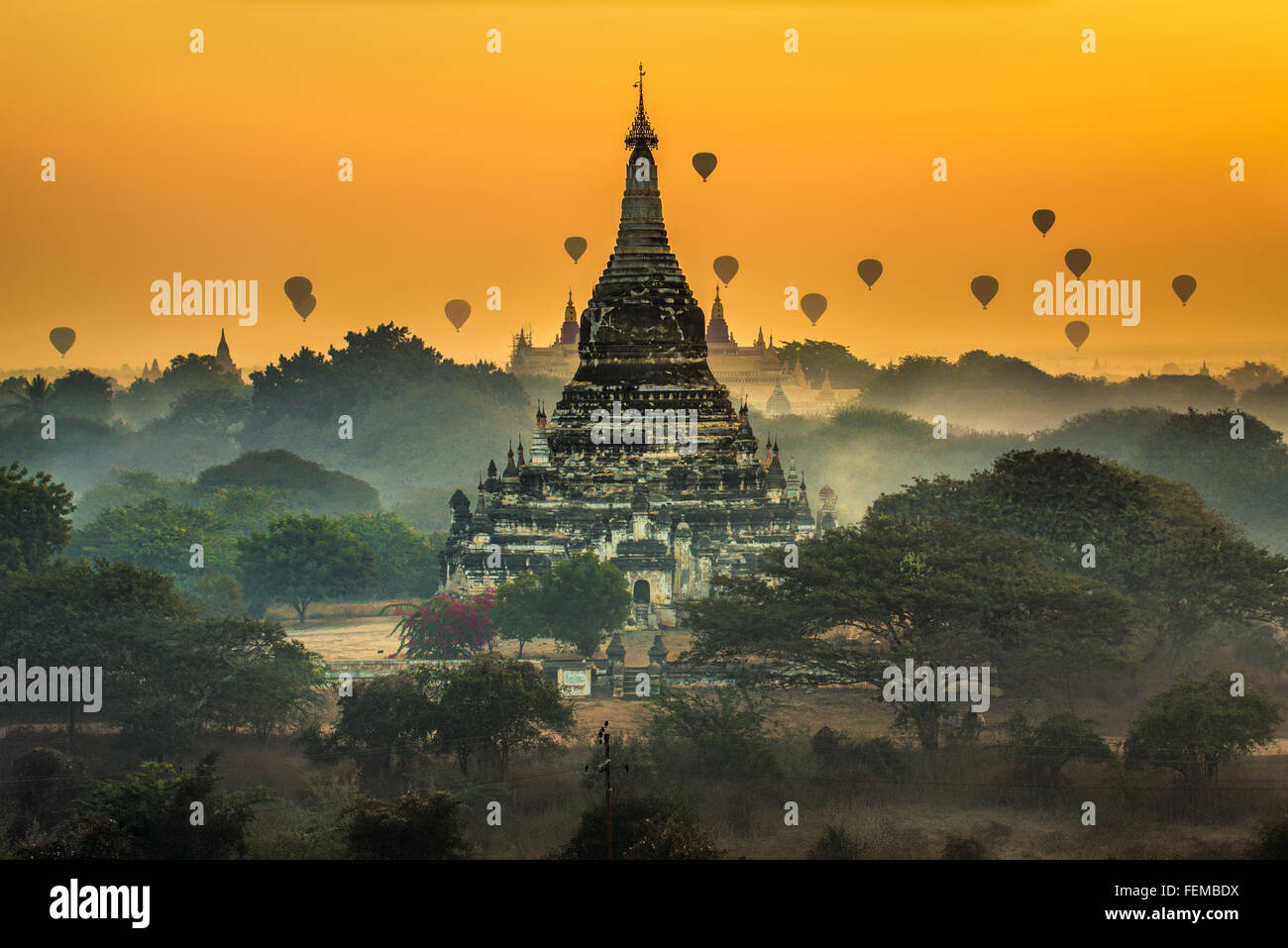 Scenic sunrise with many hot air balloons above Bagan in Myanmar Stock Photo