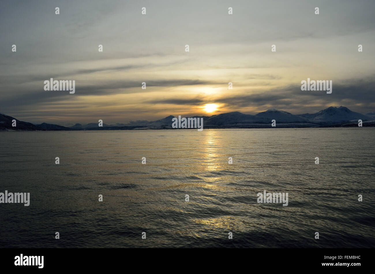 beautiful sunset over snowy mountain and fjord Stock Photo - Alamy