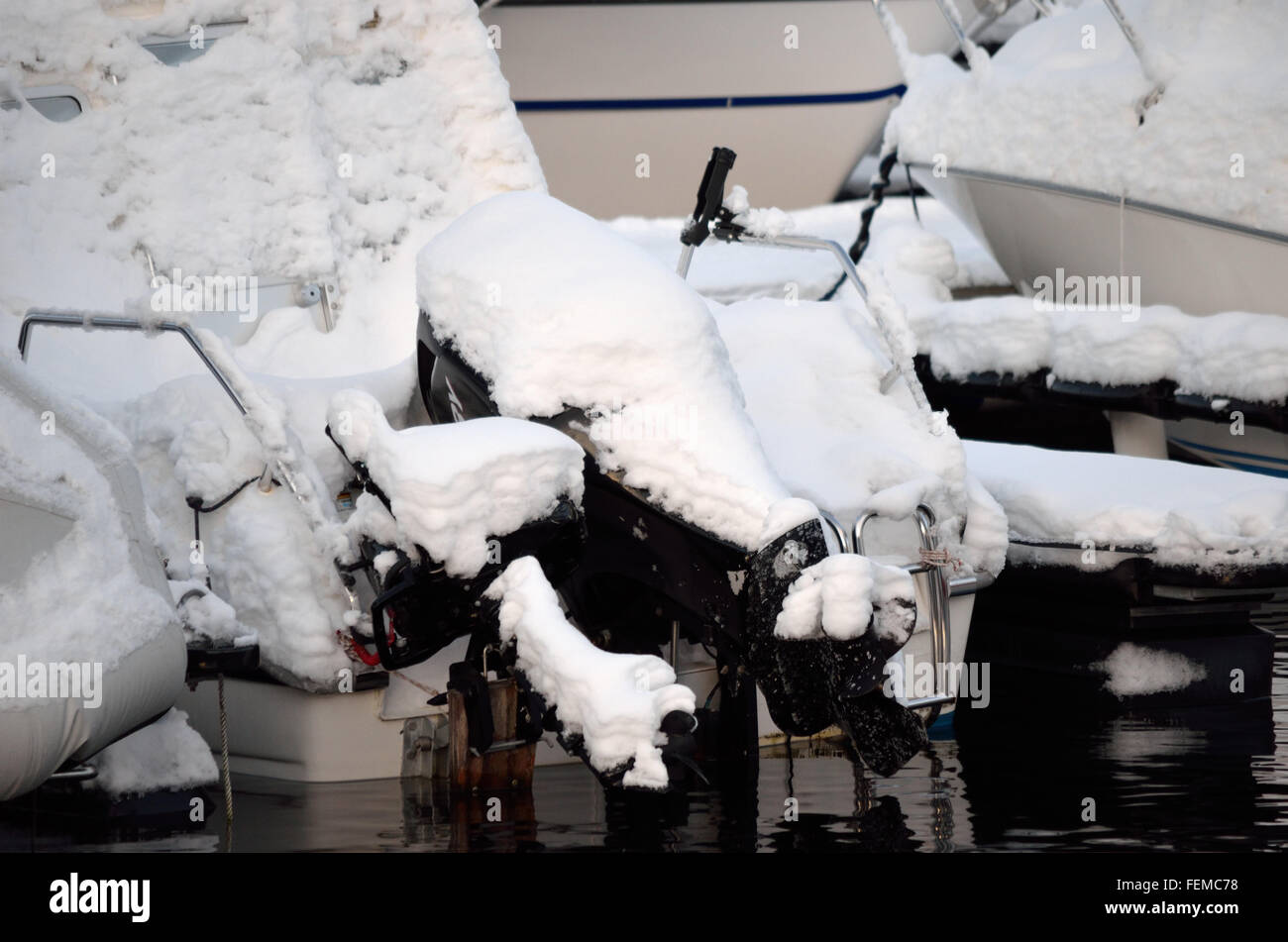 snow covered boat engine at harbor Stock Photo - Alamy