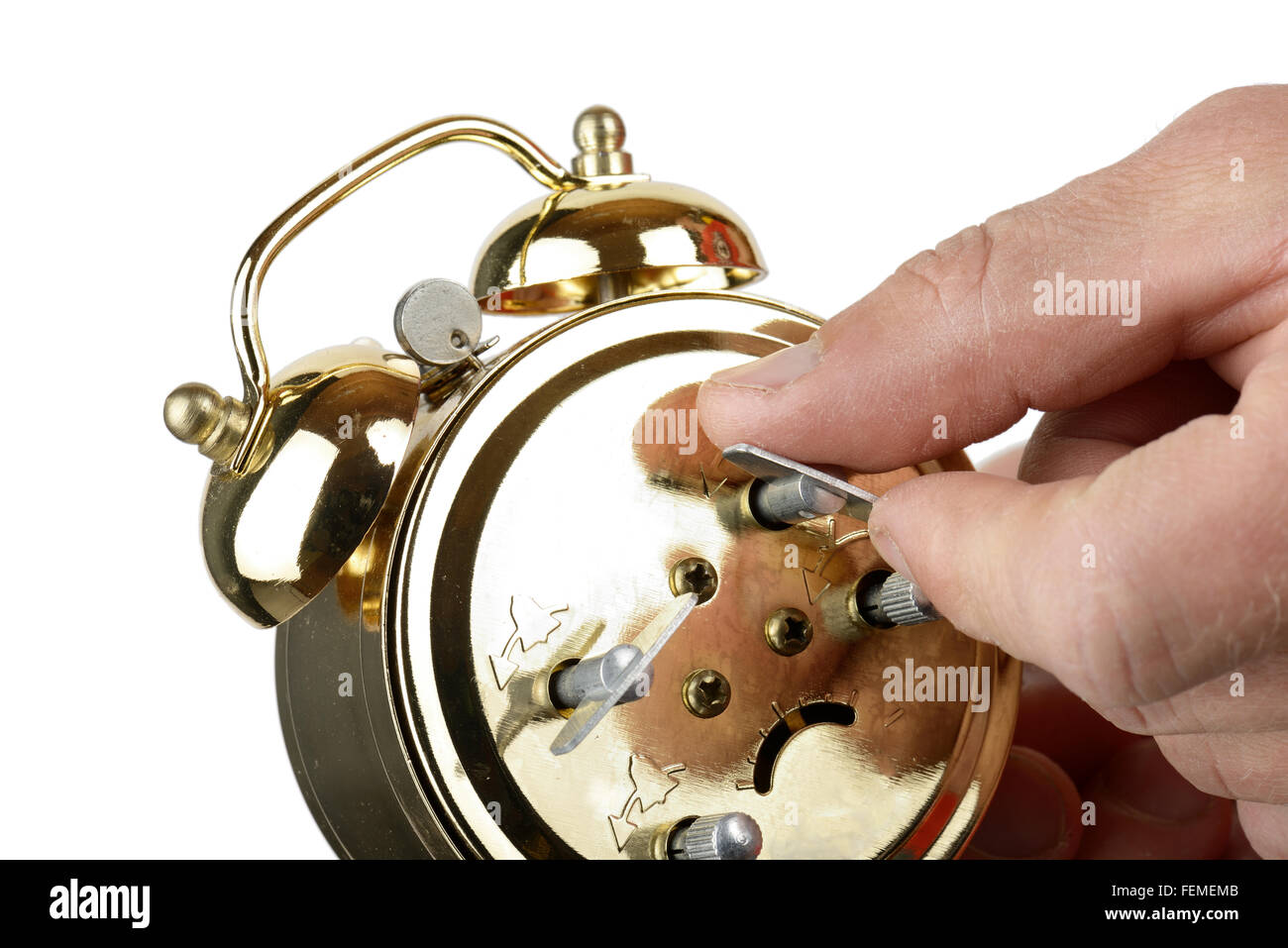 winding up a alarm clock isolated on a white background Stock Photo Alamy