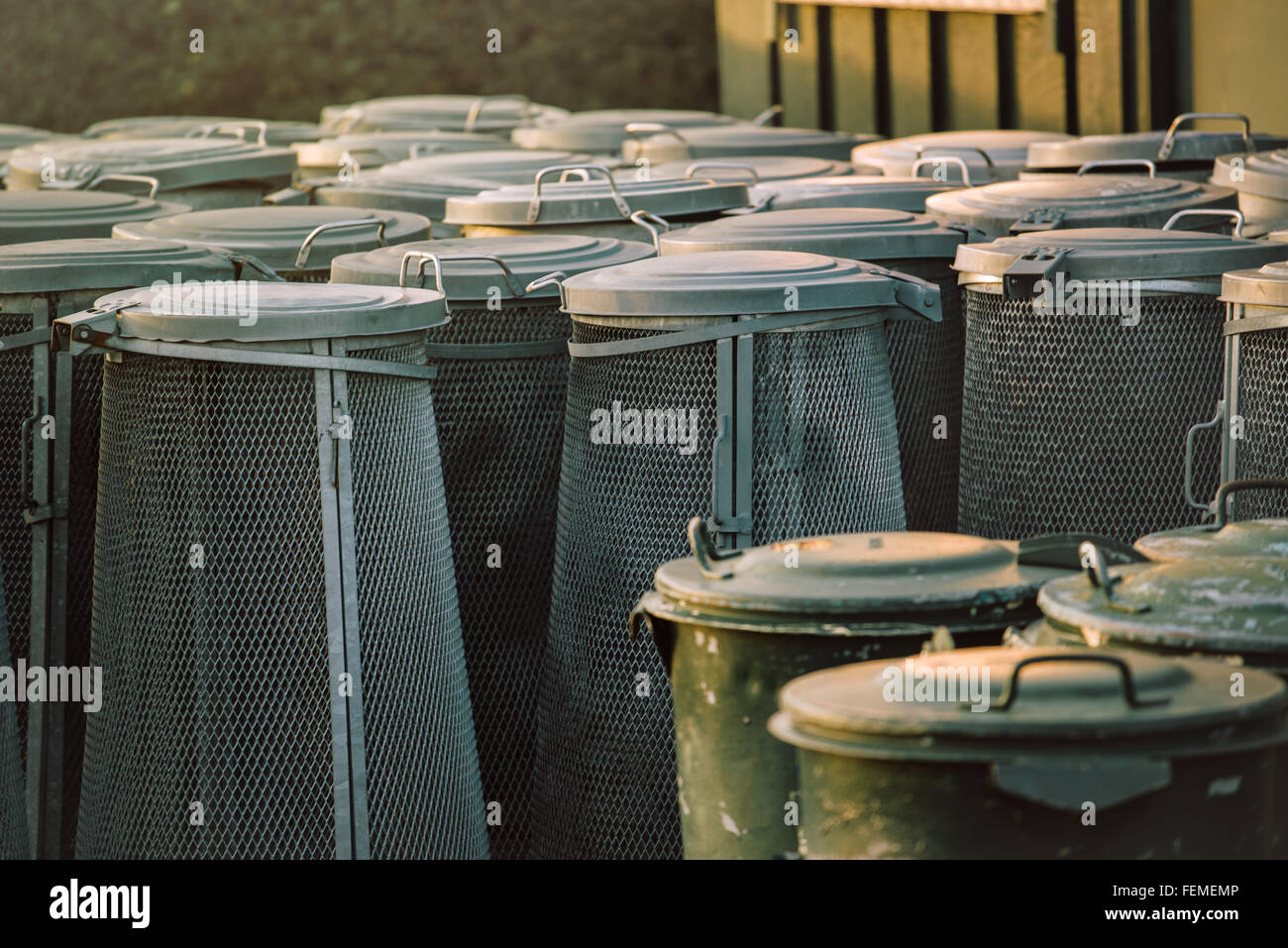 https://c8.alamy.com/comp/FEMEMP/trash-cans-piled-group-of-used-garbage-bins-FEMEMP.jpg