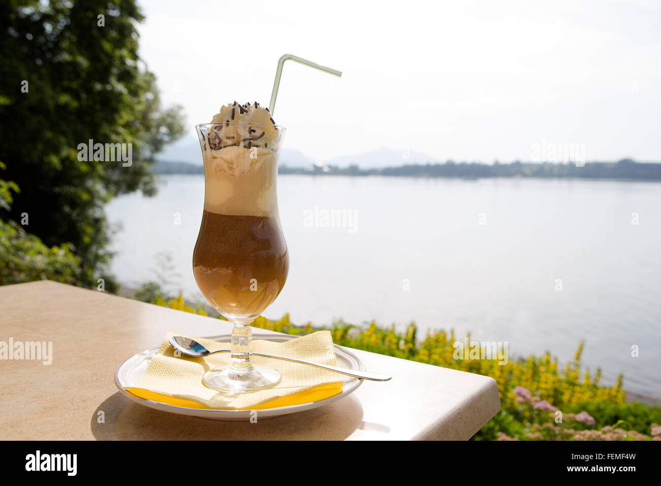 Iced coffee in summertime at a restaurant near a lake Stock Photo