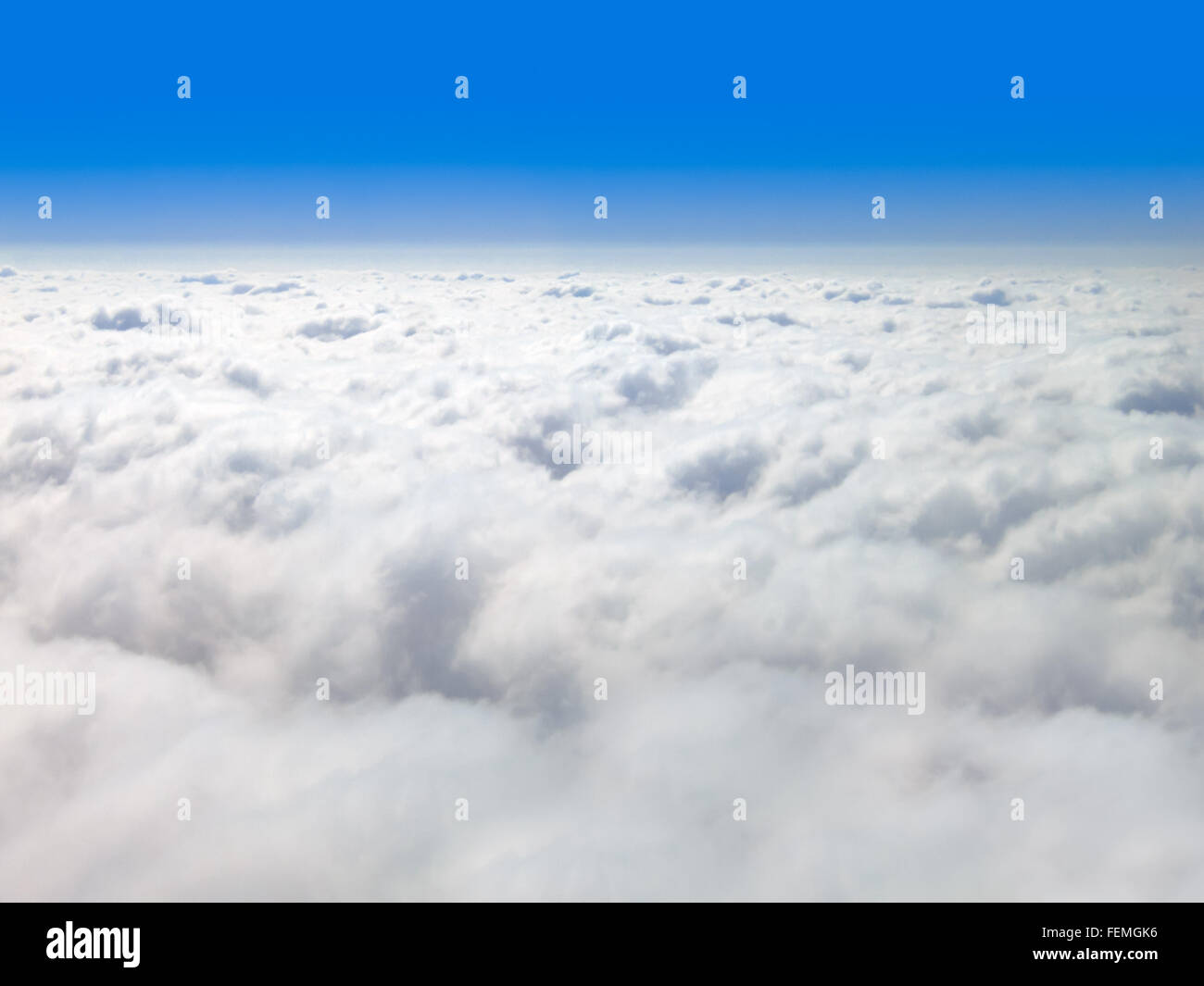 Picture of clouds from above with a blue sky horizon and copy space. Stock Photo