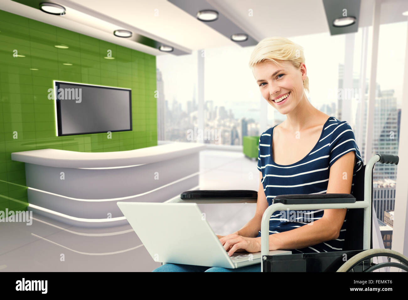 Composite image of woman in wheelchair using computer Stock Photo - Alamy