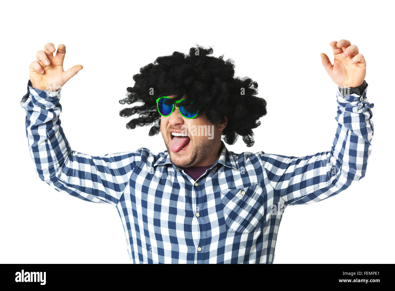Young guy having fun in black wig isolated on white background Stock