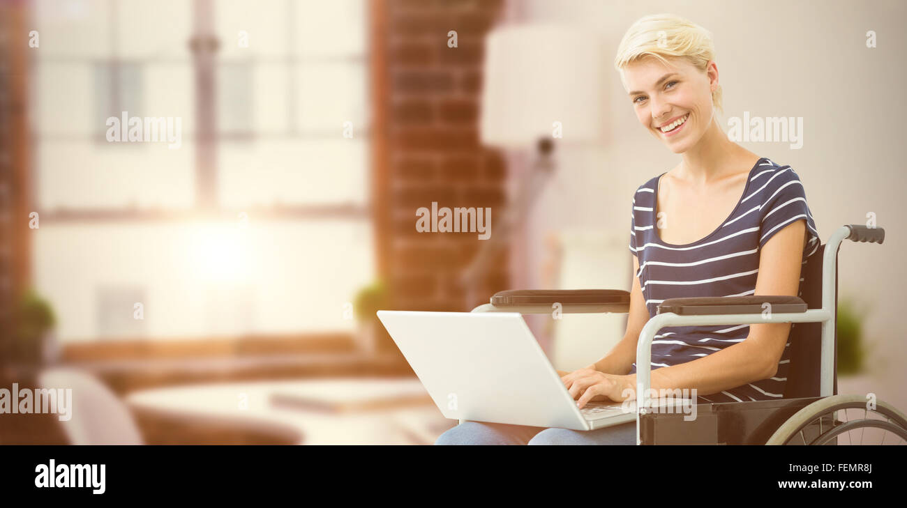 Composite image of woman in wheelchair using computer Stock Photo - Alamy