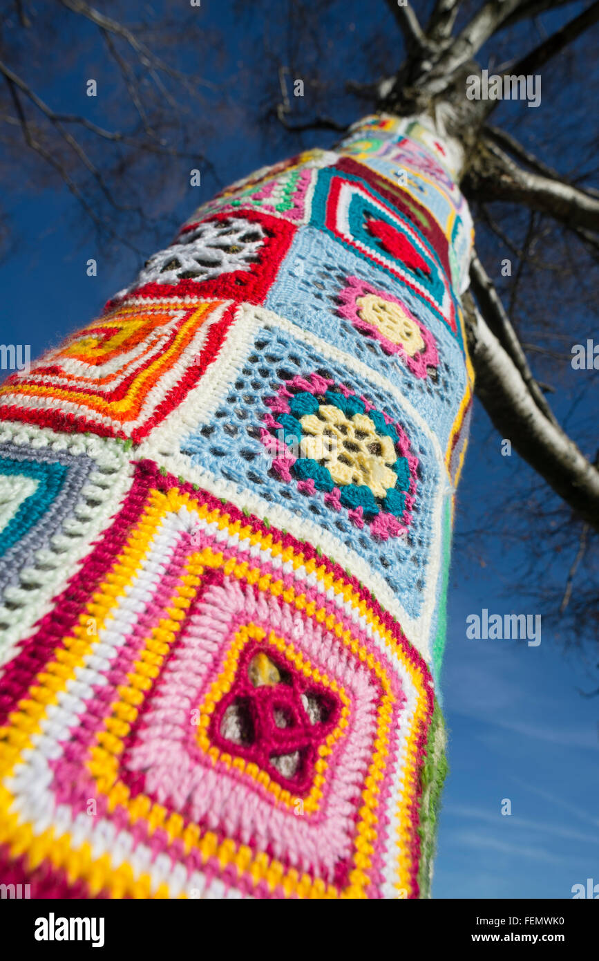 Guerilla knitting - closeup of colorful wool patterns around a tree trunk in the Olympiapark in Munich,Germany Stock Photo