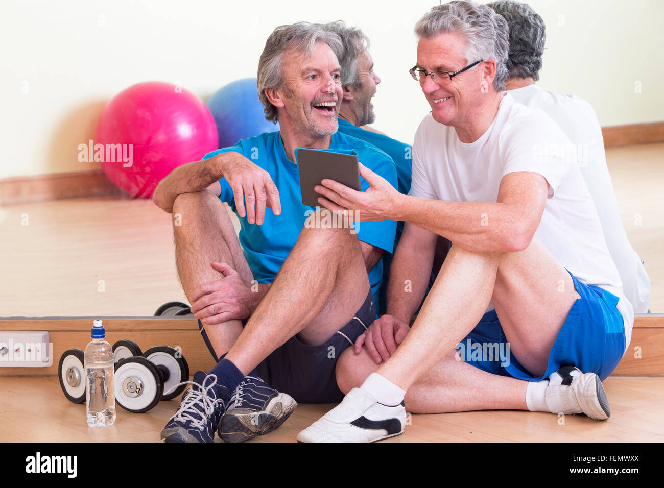 Senior men relxaing together after their workout at the gym Stock Photo