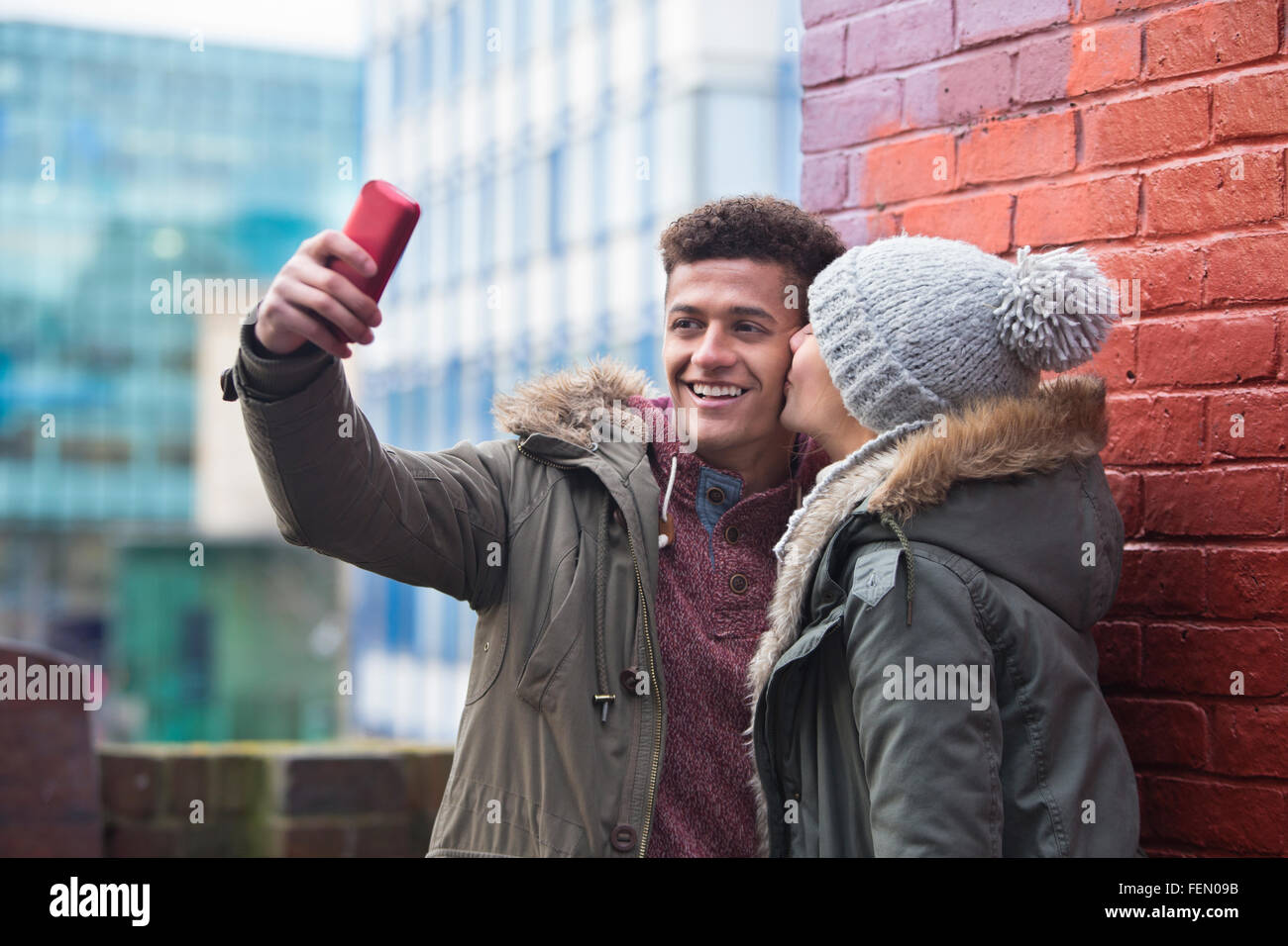 Young couple taking a selfie in the city. Stock Photo