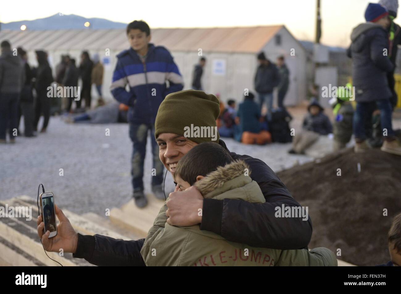 (160208) -- GEVGELIJA, Feb. 8, 2016 (Xinhua) -- Refugees make a video call with their families at a refugee camp in Gevgelija, Macedonian south border to Greece on Feb. 7, 2016.  More than one thousand migrants go across Macedonia's border everyday, most of them are from Syria, Afghanistan and Iraq. With the support of UNHCR, Macedonian government and NGOs, the refugees camps give fully free support to all the migrants transit in Macedonia, by providing sleeping mats, blankets, tents and accommodation halls, food, drinks, WIFI, medical assistance, sanitary items, as well as advice and counsell Stock Photo