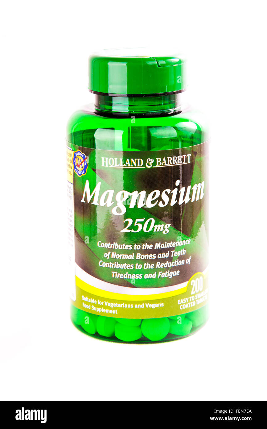 Magnesium tablets bottle for bones teeth fatigue tiredness medicine supplement diet cutout cut out white background isolated Stock Photo