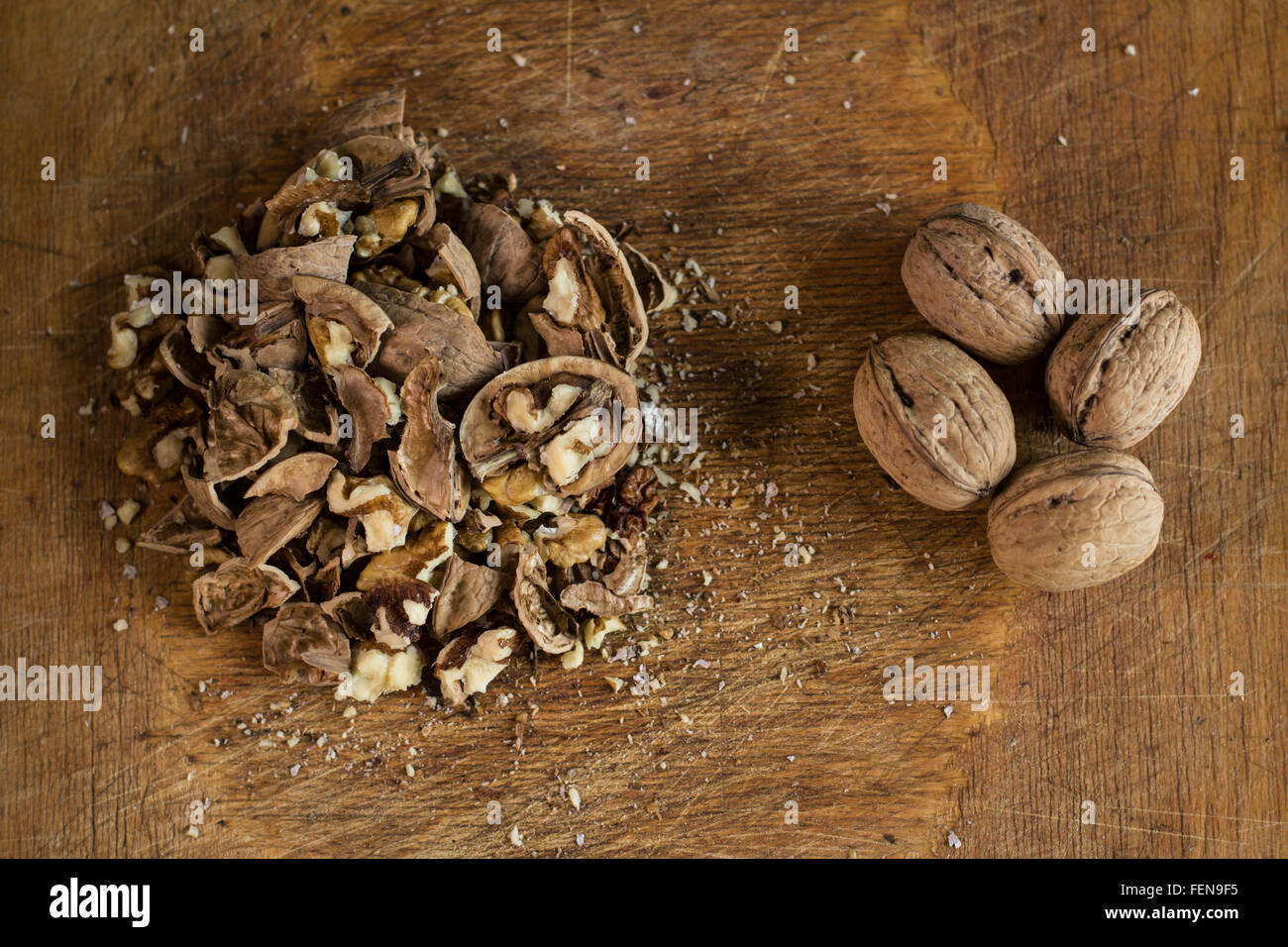 A small pile of cracked walnuts near four unbroken ones Stock Photo Alamy